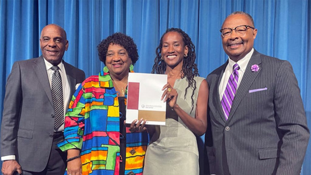 From left, state Sen. Steven Bradford, Secretary of State Shirley Weber, task force member Lisa Holder and Assemblymember Reggie Jones-Sawyer hold up a final report of the California Task Force to Study and Develop Reparation Proposals for African Americans during a hearing in Sacramento, Calif., June 29, 2023.