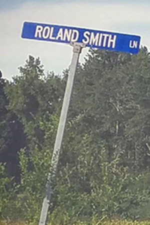 A street sign reads Roland Smith Lane. (Courtesy Evelyn Booker)
