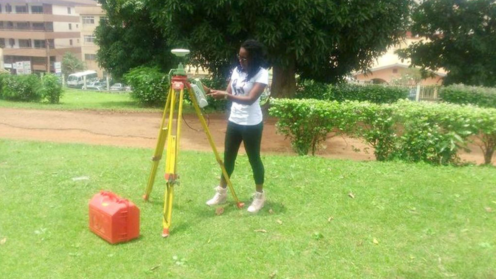 As part of her training work, Marie Makuate shows students how to use surveying equipment