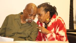 Faya Rose Toure confers with Leonard Dunston during 2016 education summit at Wallace Community College in Selma