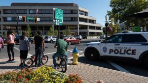 People watch as Springfield Police Department officers investigate the Springfield City Hall after bomb threats were made against buildings earlier in the day in Springfield, Ohio, on September 12, 2024.