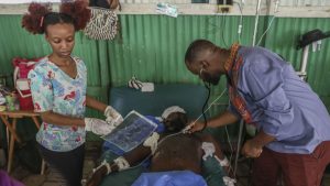 Doctors treat a man who was shot and wounded during armed gang attacks, at Saint Nicolas hospital in Saint-Marc, Haiti, Sunday, Oct. 6, 2024.