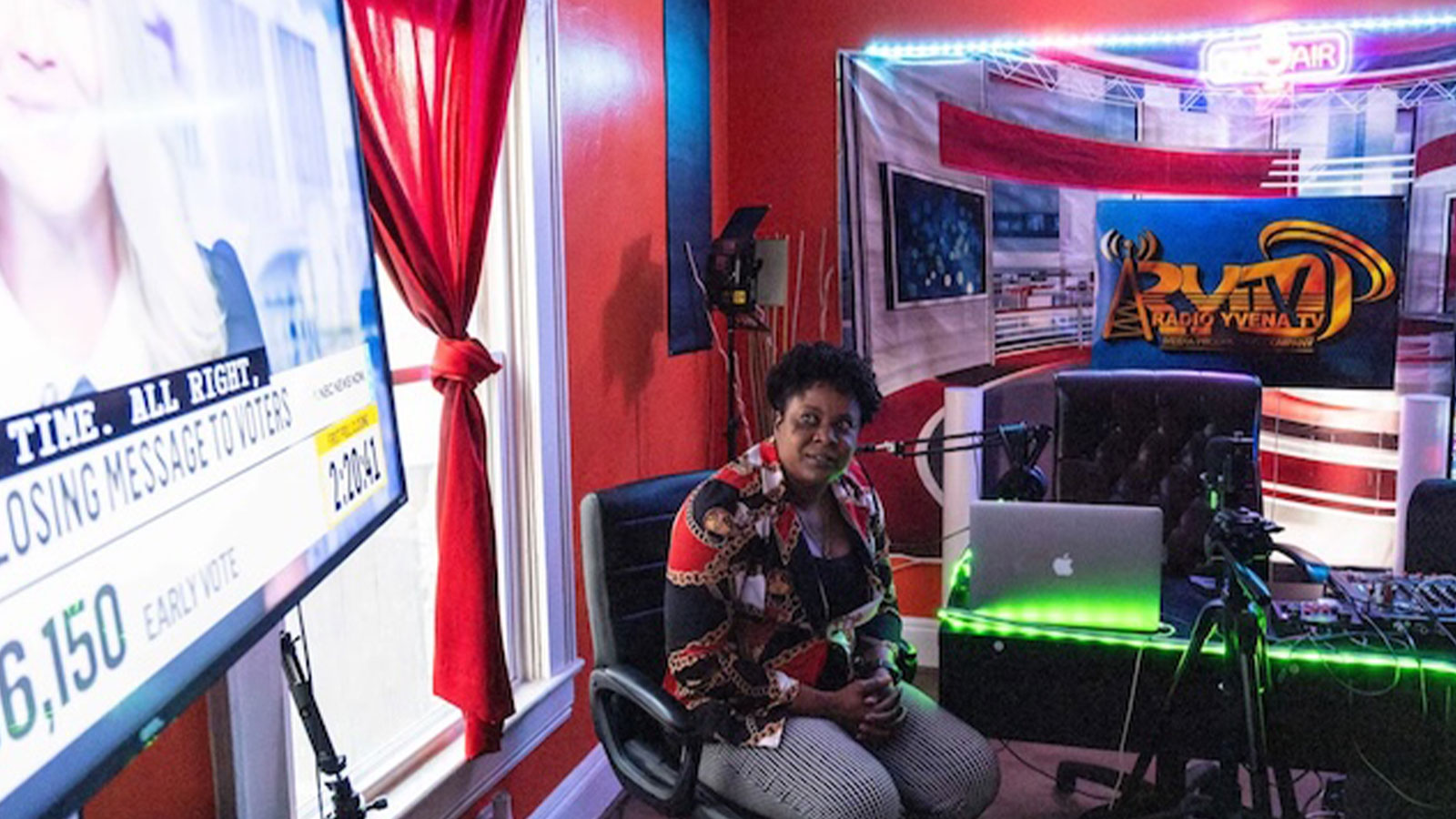 Haitian immigrant and podcaster Yvena Jean François watches election coverage from her home studio.