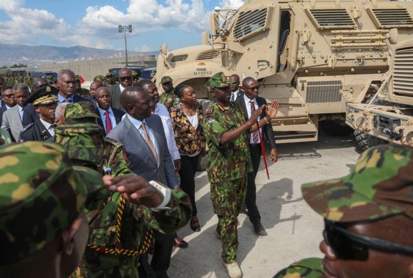 Kenya's President William Ruto, center left, visits Kenyan police, part of a UN-backed multinational force, at their base in Port-au-Prince, Haiti, Saturday, Sept. 21, 2024.