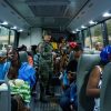 A soldier chats with a Haitian mother on a bus heading to the border of the Dominican Republic and Haiti where she is being deported.