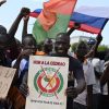 A small group of protesters hold Russian and Burkina Faso flags as they protest against ECOWAS in Ouagadougou in October 2022,