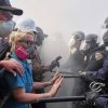 Protesters confront police on the 101 Freeway near the Metropolitan Detention Center of downtown Los Angeles, Sunday, June 8, 2025, following last night’s immigration raid protest.
