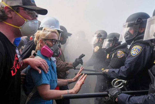 Protesters confront police on the 101 Freeway near the Metropolitan Detention Center of downtown Los Angeles, Sunday, June 8, 2025, following last night’s immigration raid protest.