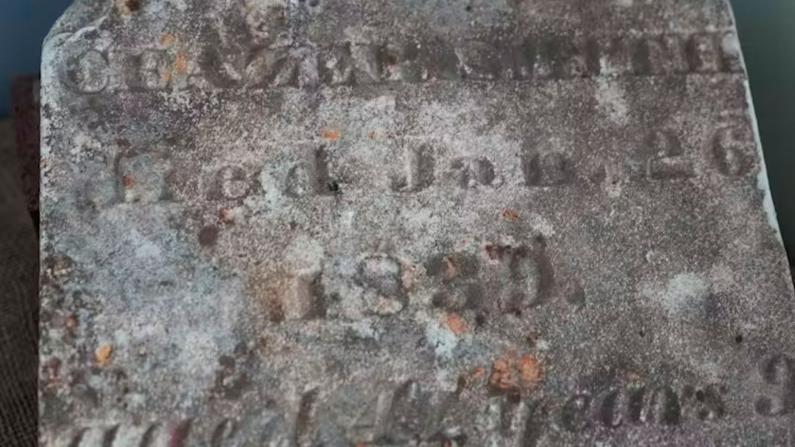 A tombstone bearing the name of Caezer Smith and dated 1839 is displayed on the site of a recently rediscovered African burial ground in Kingston, N.Y., in August 2024.
