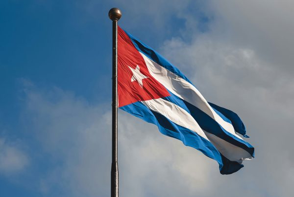 Cuban flag flying against the sky.