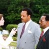 Dr. Ron Daniels and Rev. Jesse Jackson standing together during a televised news interview in the 1980s.