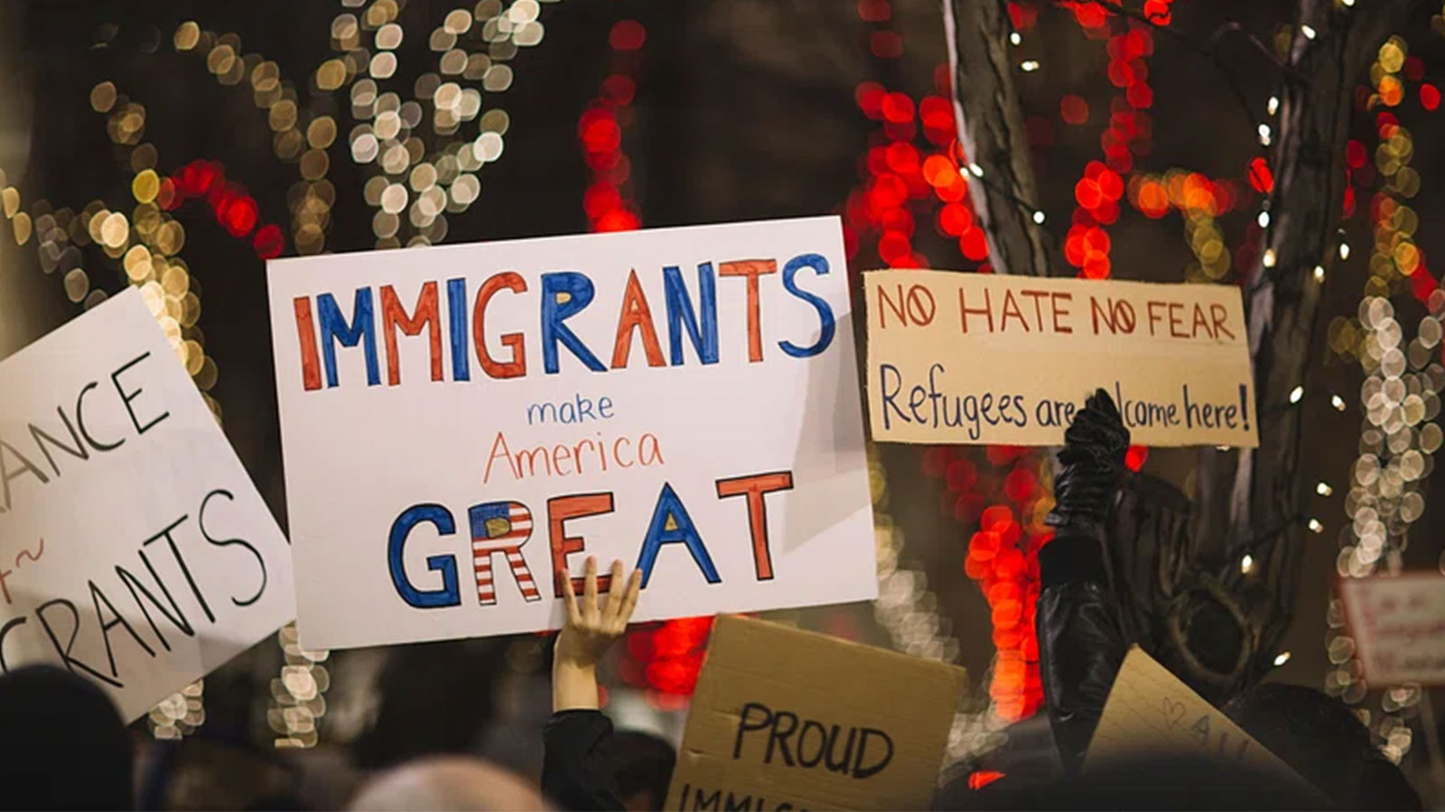 A rally sign expressing support for immigrants during a public demonstration. Public domain image via Wikimedia Commons.