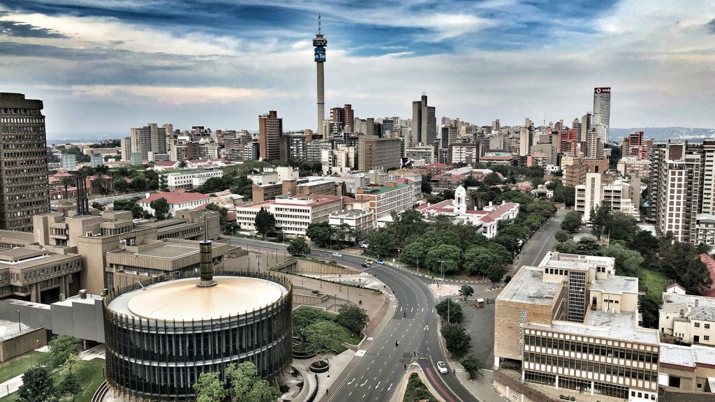 Skyline of Johannesburg, South Africa, viewed from above with city buildings and roads.